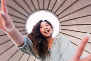 Happy woman with long hair dancing under canopy