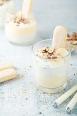 Milk mousse dessert with nuts in glasses