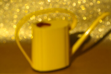 yellow watering can  on gold background, art