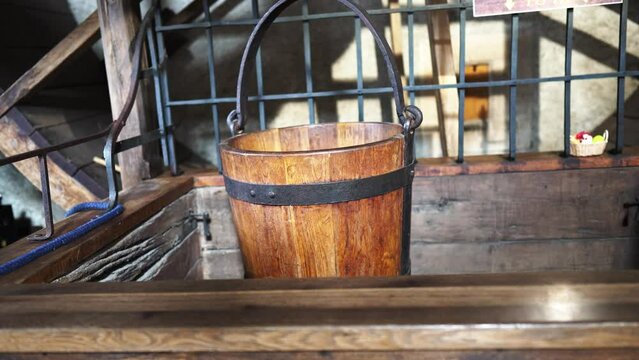 Czech Karlstein Castle, an old well and a wooden bucket. High quality 4k footage
