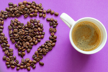 white cup of black espresso coffee on purple violet background, with a place for inscription,  with heart shaped coffee beans 
