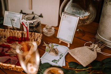 Valmiera, Latvia - Augist 13, 2023 - A table setting with a framed blank sign, burlap pouch, and decorative items.