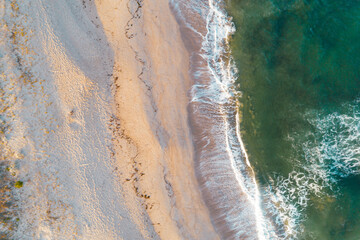Fototapeta na wymiar Top view aerial photo from flying drone of an amazing seascape with paradise beach and sea with turquoise water. Summer vacation holidays, website background with copy space area