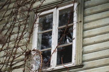 Broken window in an old wooden house. - obrazy, fototapety, plakaty