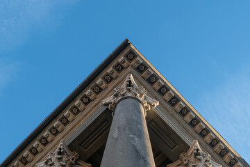 neoclassical column and capital rise towards the sky. Architecture that enhances the classical...