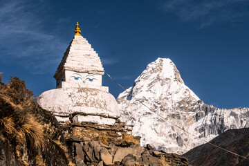 Tibetan Buddshims stupa with Ama Dablam peak near Namche Bazaar in the Himalaya in Nepal