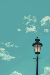 Isolated lamppost against blue sky - obrazy, fototapety, plakaty