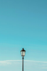 Isolated lamppost against blue sky