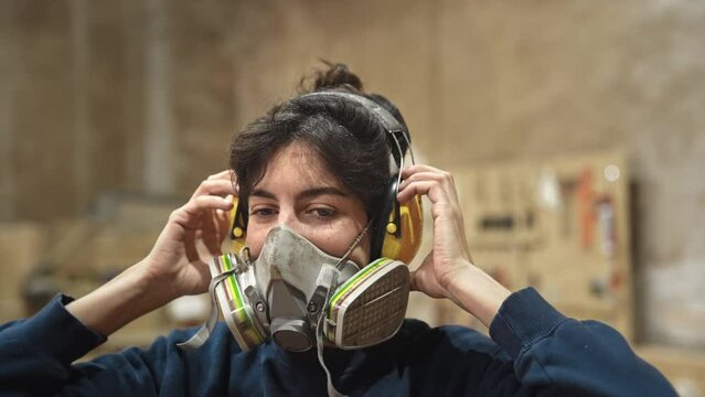 Woman carpenter wear respirator. Feminist girl process wood. Female joiner woodwork. Feminism worker in noise canceling headphones. Person use protective dust mask. Master class workshop. Male work.