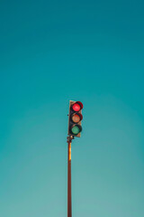 An isolated lamp post against blue sky