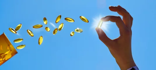 Gordijnen Flying Vitamin D Pills with Woman Hand in Summer Sun - Panorama © ExQuisine
