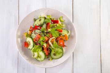 Salad of fresh cucumbers, celery, sweet peppers, herbs and pumpkin seeds, sunflowers, sesame seeds with olive oil. Healthy vegetarian, vegan food. Italian Cuisine