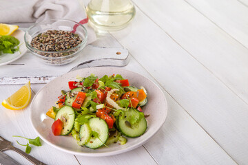 Salad of fresh cucumbers, celery, sweet peppers, herbs and pumpkin seeds, sunflowers, sesame seeds with olive oil. Healthy vegetarian, vegan food. Italian Cuisine