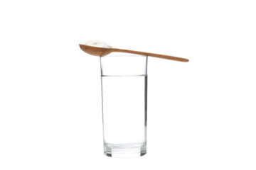 PNG,A wooden spoon with collagen and a glass of water, isolated on white background