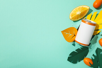 Tin can, citrus fruits and paper leaves on green background, space for text