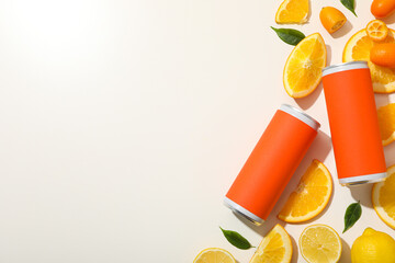 Tin cans and citrus fruits on white background, space for text