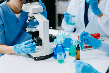 Team scientists conducting research investigations in a medical laboratory, a researcher in the...