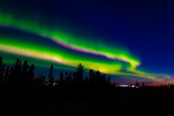 Fototapeta na wymiar Green neon Aurora Borealis in the sky