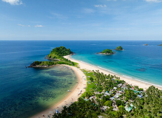Twin Beach and Nacpan Beach with boats on cream colored sands. El Nido, Palawan. Philippines.