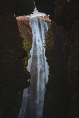 Vertical shot of Gljufrabui waterfall in the forest in Iceland