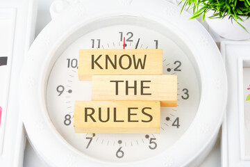 Know the rules text on the wooden blocks on the clock with hands