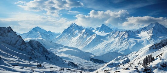 Obraz premium Breathtaking Snow-Capped Mountains Under Blue Skies