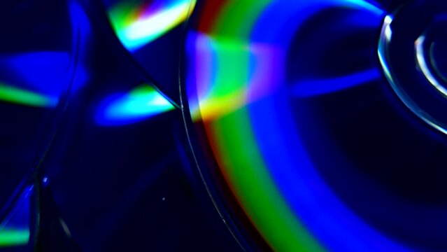 Closeup video of colorful dvd discs with iridescent highlights on the surface
