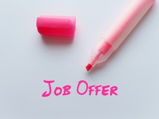 Highlight pen with pink written text JOB OFFER -  invitation from employer for potential employee...