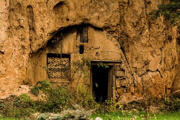 Ancient cave house surrounded by vegetation