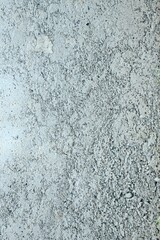 Vertical shot of a concrete gray wall pattern.