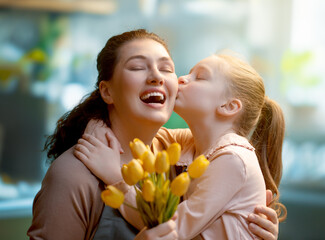 daughter and mom with flowers - 779552835