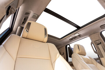 Beige leather front seats for driver and passenger with music speakers