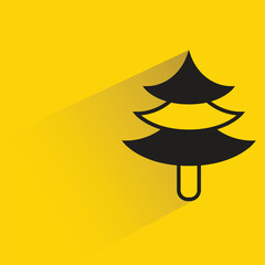 Christmas tree icon with shadow on yellow background