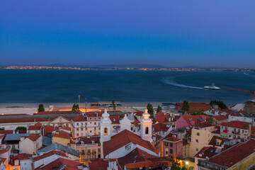 view of Alfama old town and Tajo river at blue night, Lisbon, Portugal, toned