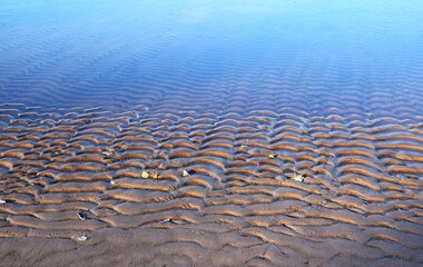 Pattern on sandy Beach with blur blue background