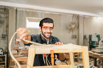 Diligently skilled man work with wood in carpenter's shop, using tools and equipment to transform timber planks into bespoke wooden pieces, craftsmen workshop with natural material, furniture industry