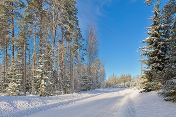 The snow has been plowed from the road in cold winter weather, Loppi, Finland.