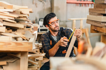 Carpenter working with electric planer on wooden plank in workshop. Craftsman makes own successful small business, man using tool in carpenter's shop to making a furniture from wood - obrazy, fototapety, plakaty
