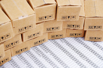 Caro and logistic business concept. Many carton boxes on financial documents.	