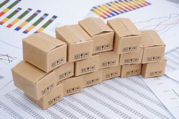 Managing shipment and cargo concept. Many carton boxes on financial documents.