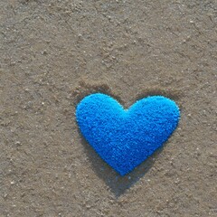 a blue heart shape on sand is shown in the middle