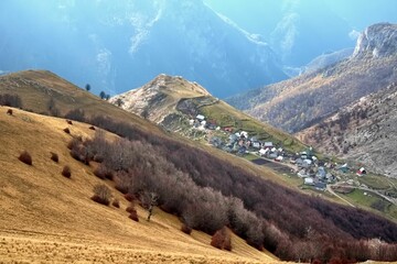 Scenic shot of houses on the slopes of a mountain in a nature park on an autumn day