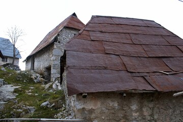 Closeup shot of abandoned houses with old and rusty roofs in a village