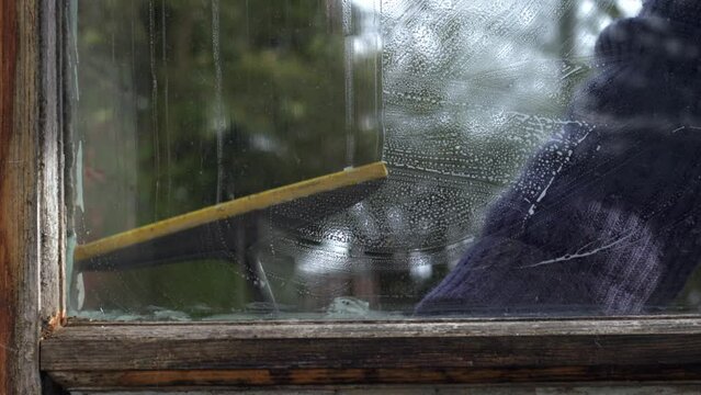 Hand washing window with soapy water and cloth