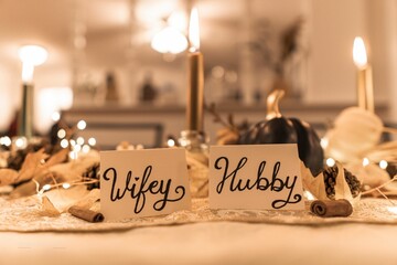 Wifey and Hubby decorations put on the Thanksgiving dinner table on blurred background
