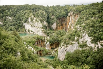 Gorgeous view of the Plitvice Lakes National Park in Croatia with bushy trees and waterfalls