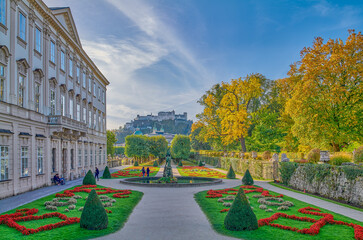 Salzburg, Austria -  October 6, 2022: The garden of the Mirabell palace with the old town and the...