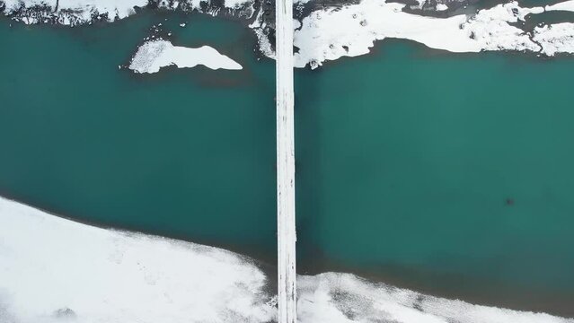 Top view of a bridge covered with snow in Skardu city, Pakistan. Drone shot.