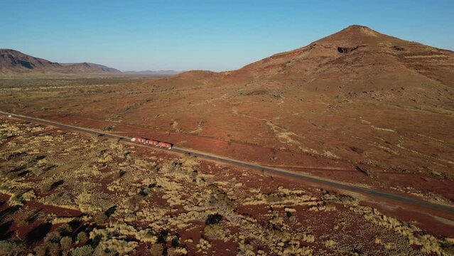 A road train passes through Aboriginal land near Mount Bruce in Western Australia.