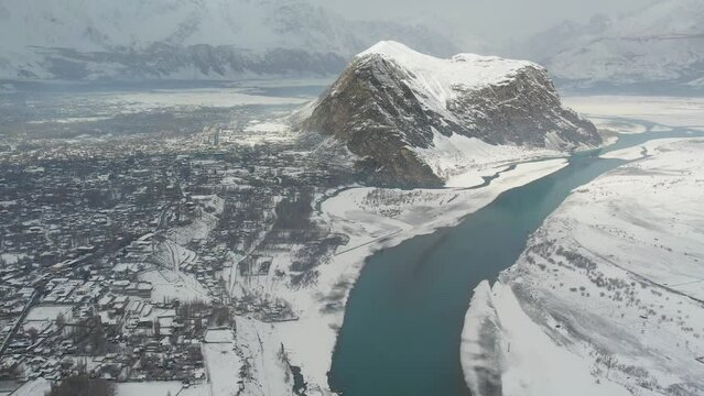 Aerial view of turquoise rivers and mountains and Skardu city in Pakistan.